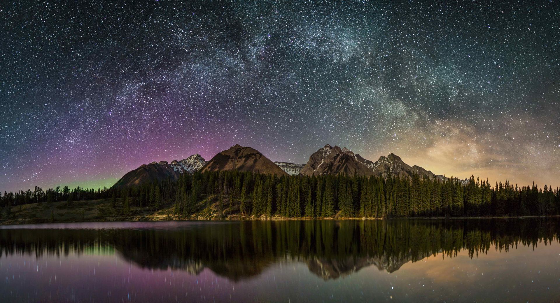 Starry night sky over mountain at Johnson Lake.
