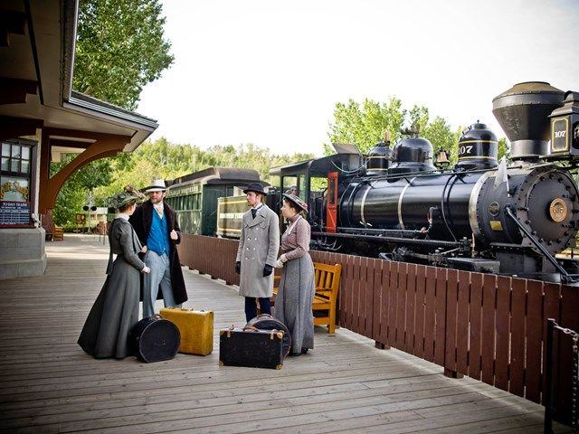 Historical actors in front of the Steam Train at Fort Edmonton Park.