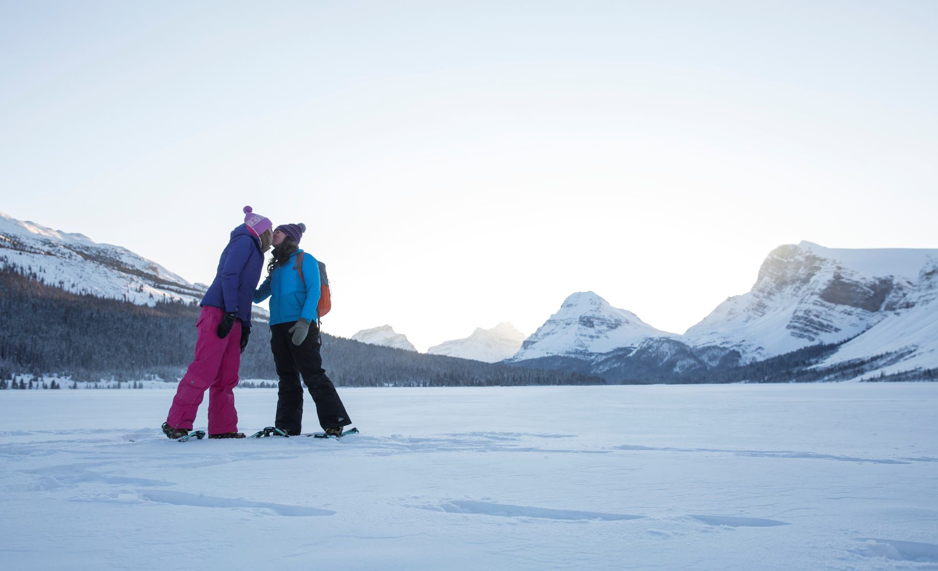 Couple kissing while snowshoeing on Bow Lake.