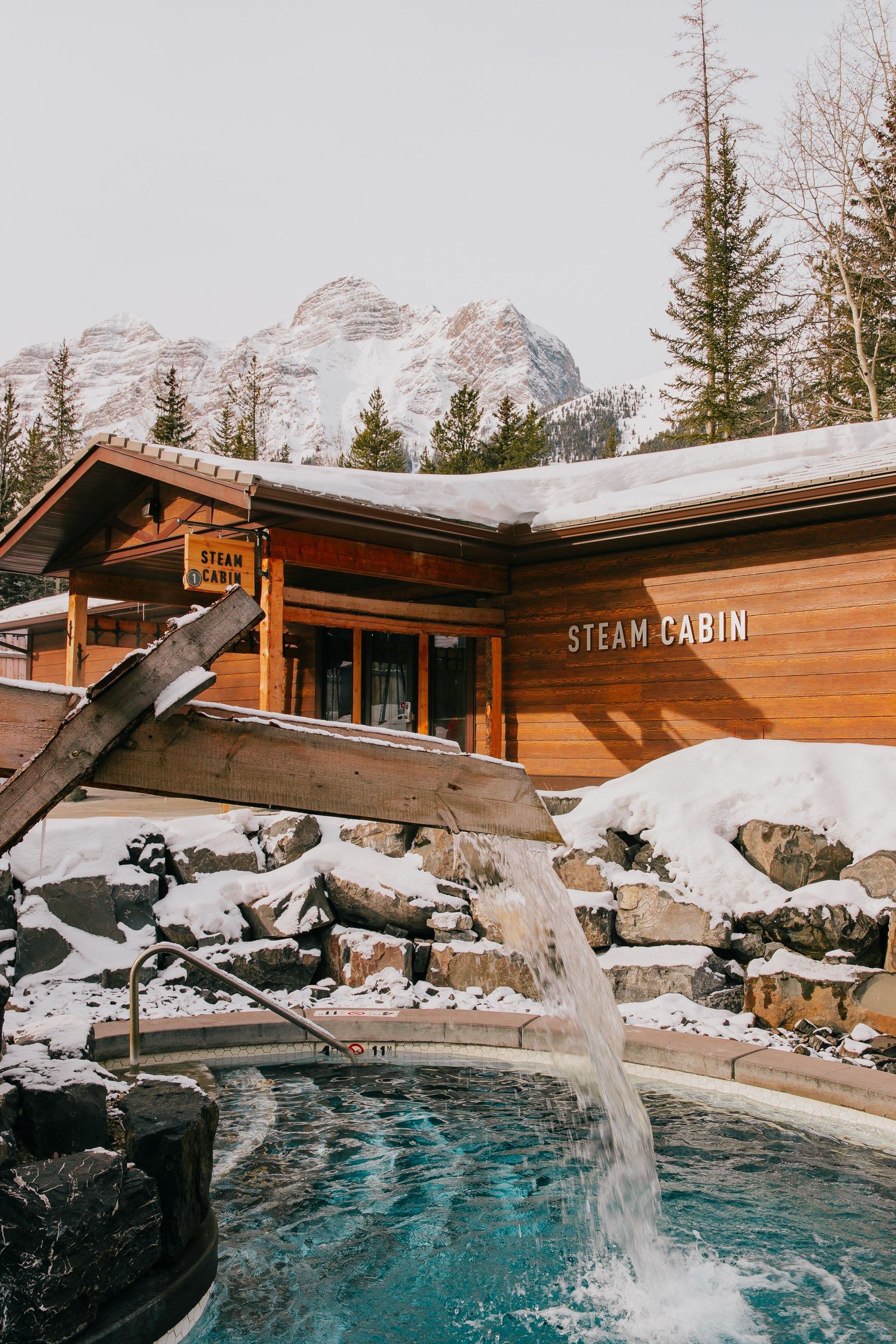 A chute spills water into a pool at the Kananaskis Nordic Spa.