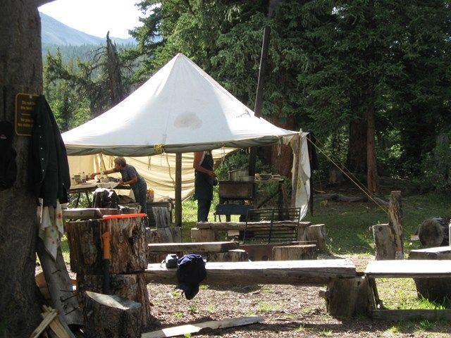staff cooking under a tent