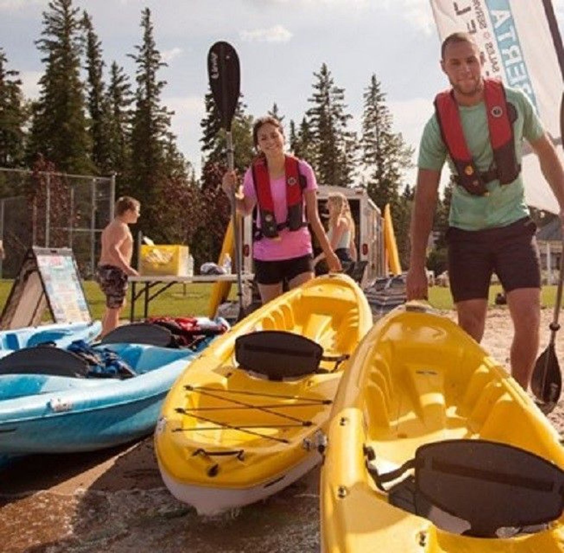 Two people with kayaks