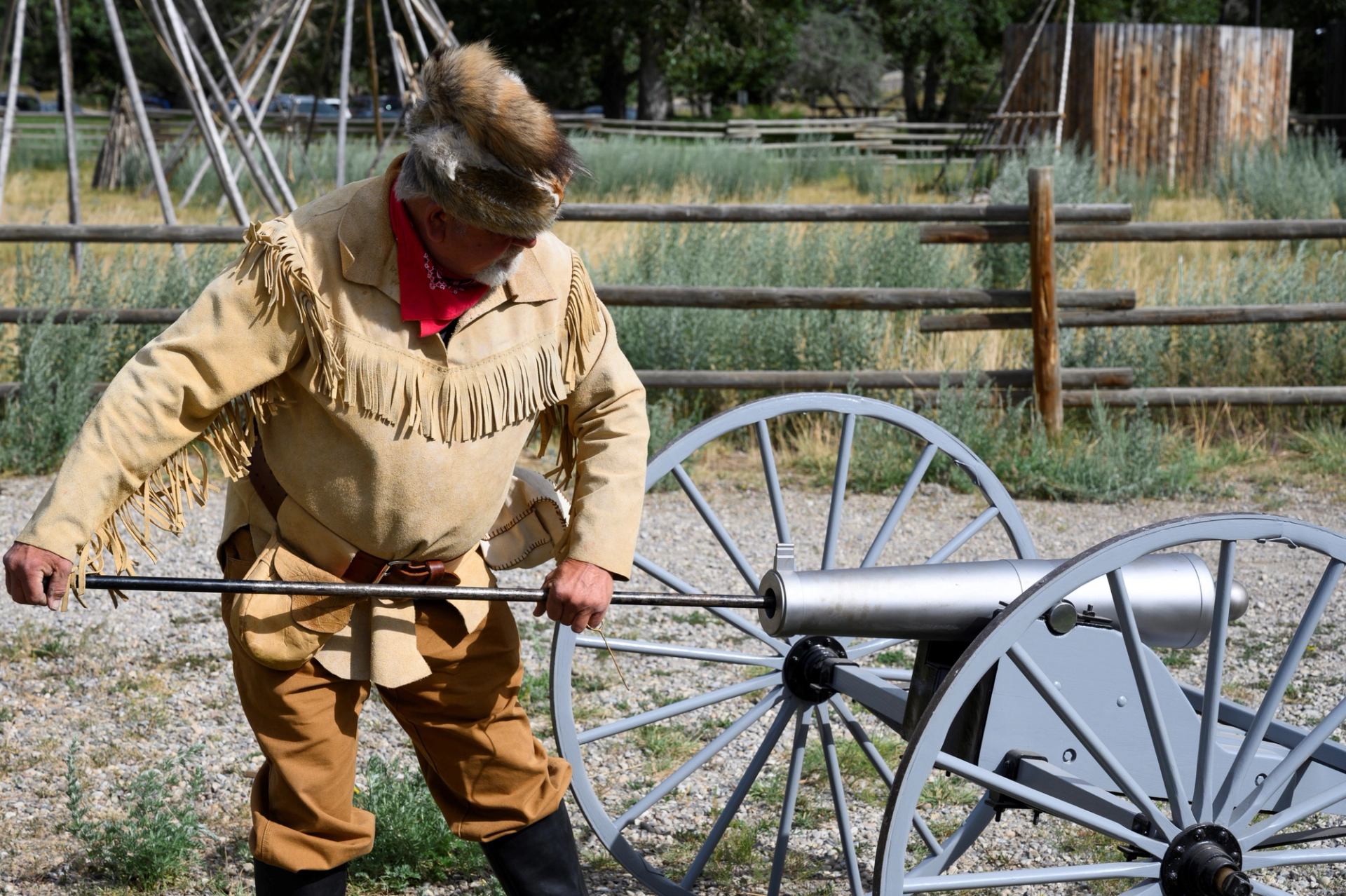 A man in historical clothing operating a cannon