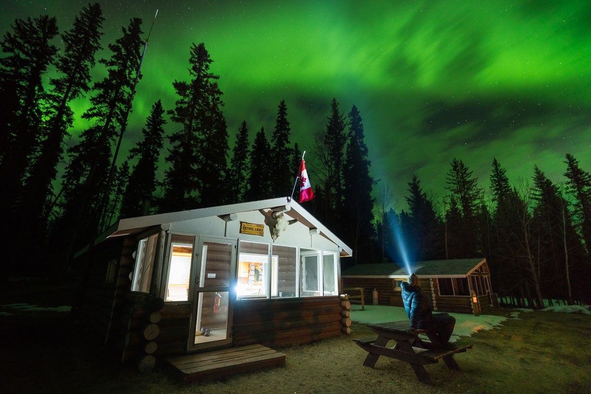 A person looking at the Northern Lights in Wood Buffalo National Park.