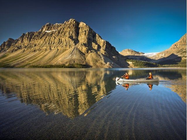 Two people in a canoe on Bow Lake in Banff National Park.