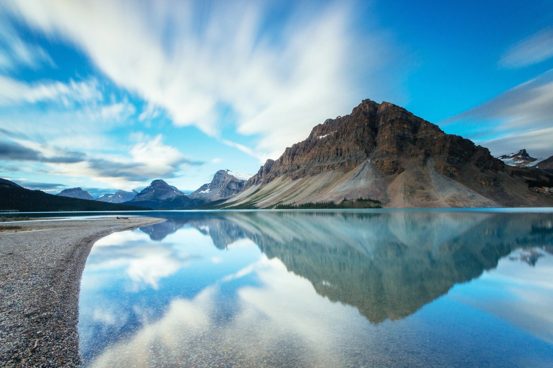 Mountains reflecting in Bow Lake along the Icefields Parkway.