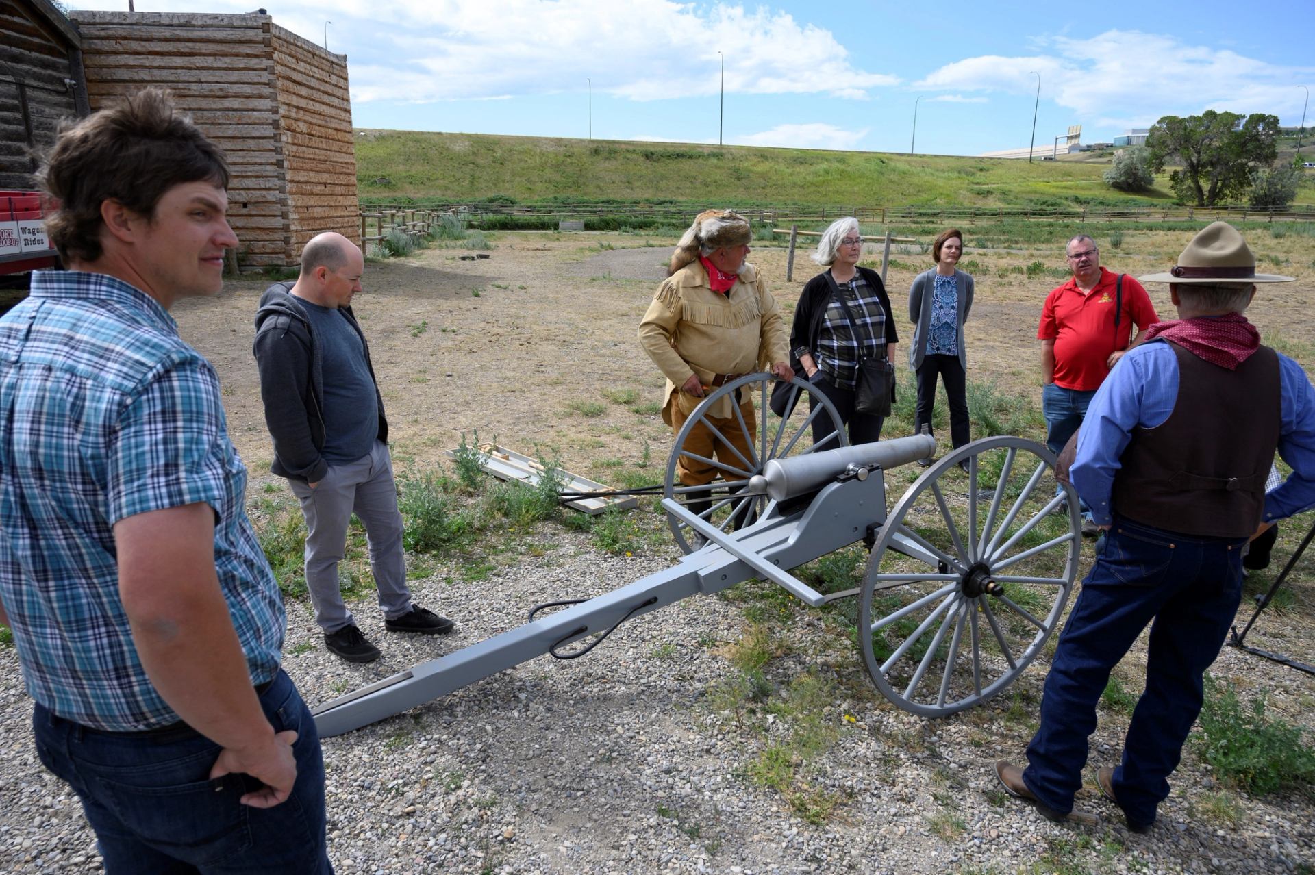 A group of visitor stood around a canon