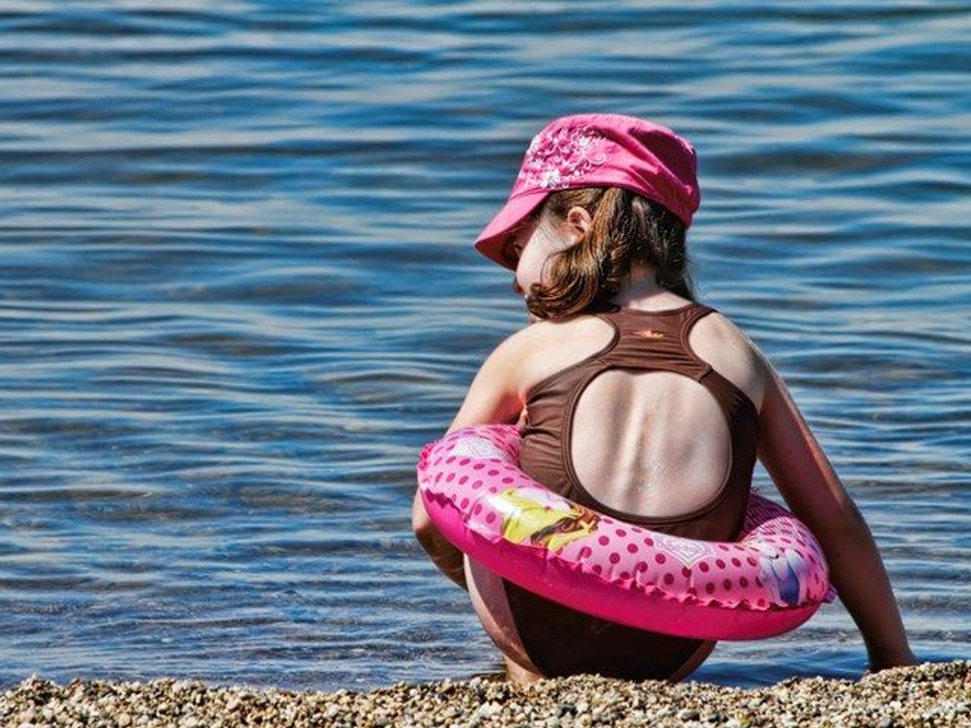 A child playing on the shore.