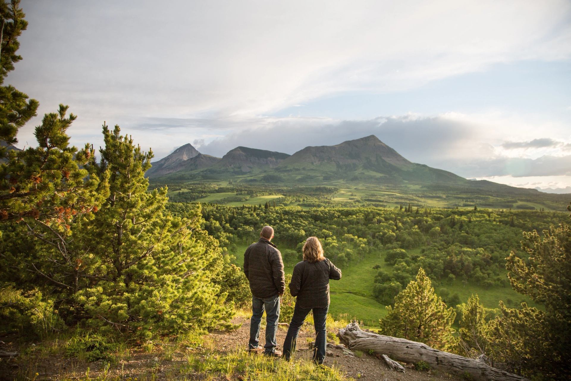 Two people stood enjoying the sunset