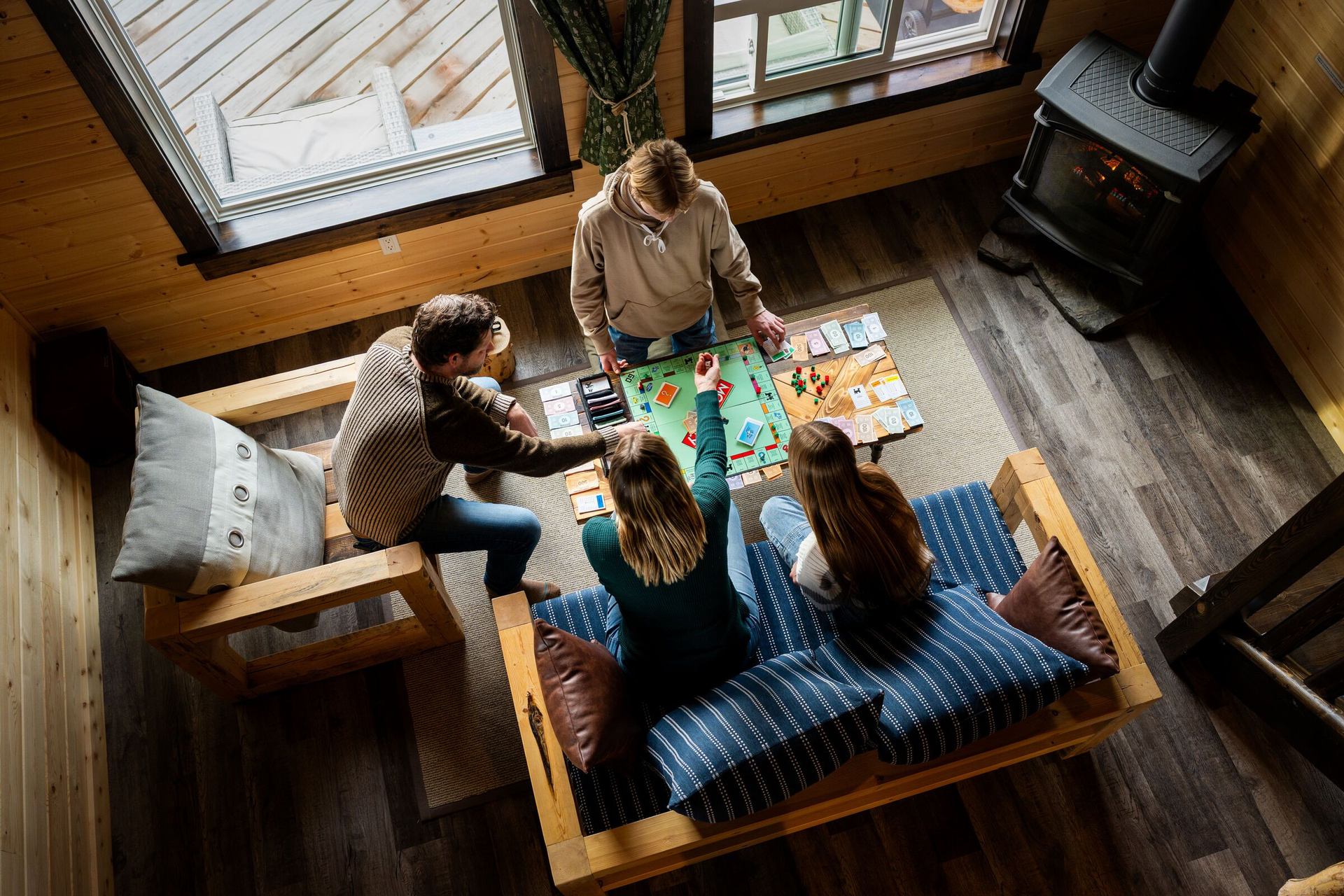 Family playing a boardgame at Expanse Cottages.
