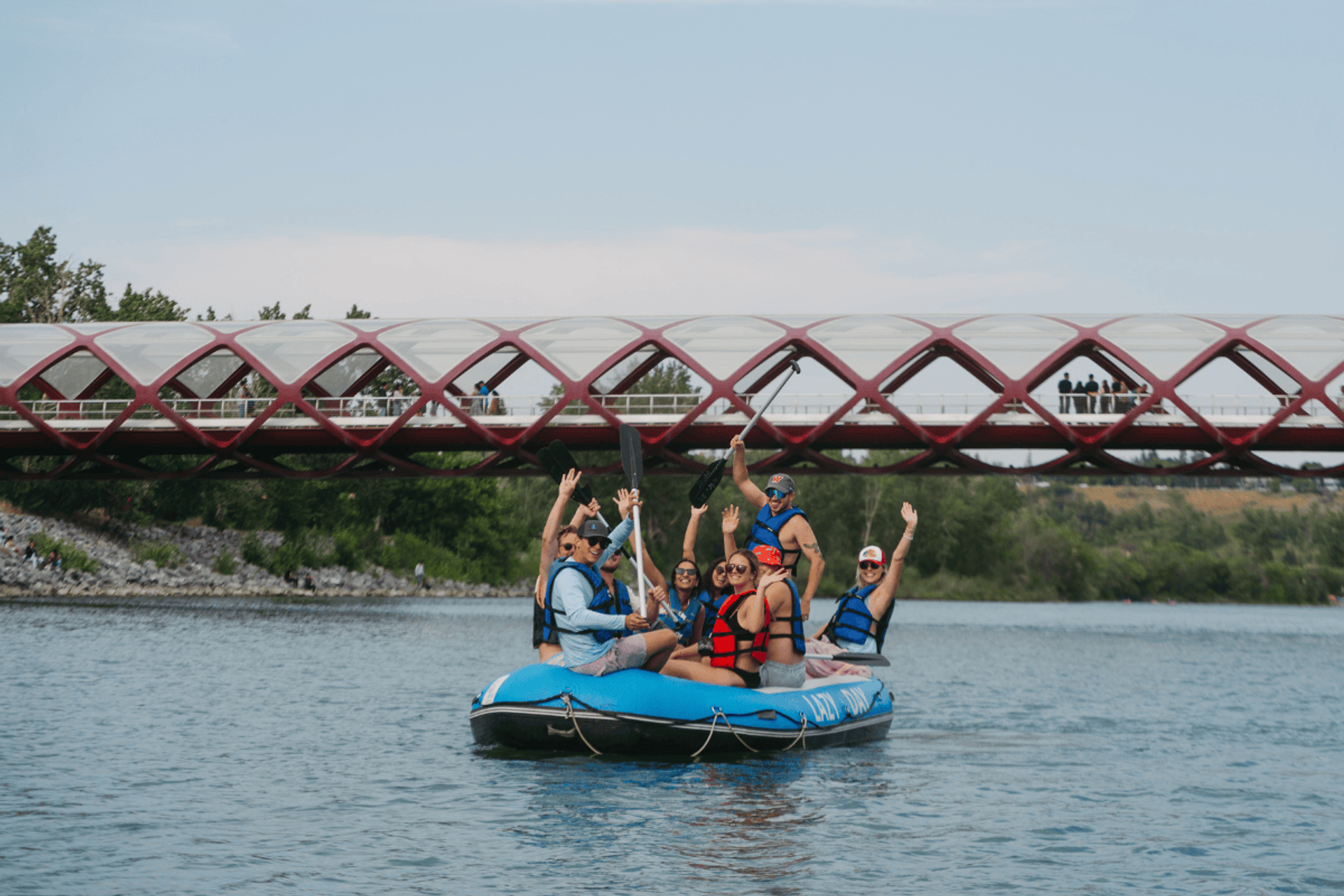 A group floating under the picturesque Peace Bridge