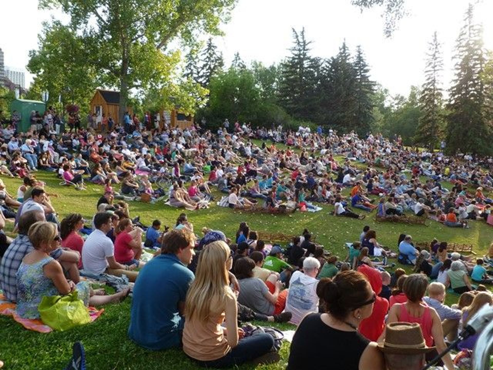 Crowd of people waiting for an outdoor concert at Prince's Island Park.