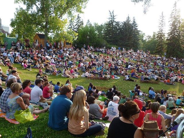 Crowd of people waiting for an outdoor concert at Prince's Island Park.