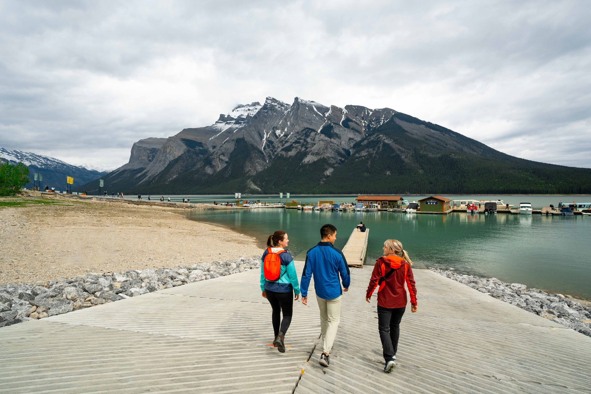 People walking on the dock towards Lake Minnewanka.