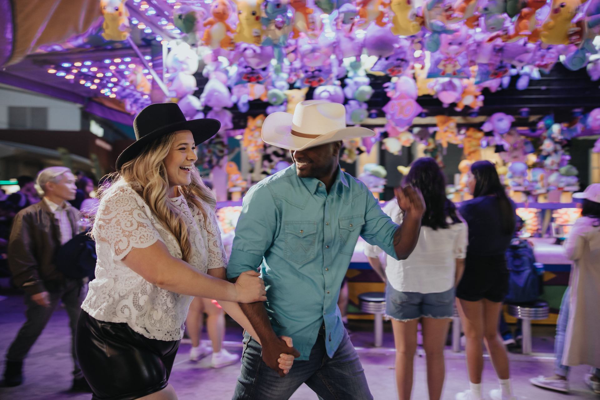 Couple walking through the midway at the Calgary Stampede.