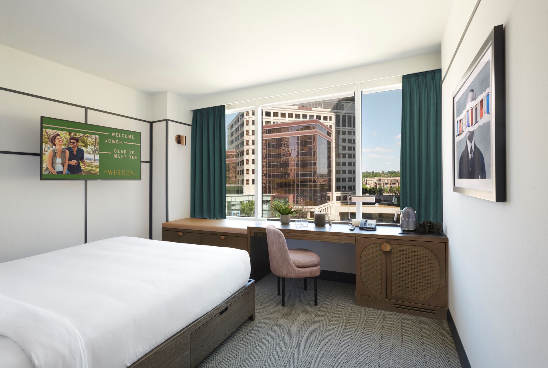 A guest room with bed, desk and chair