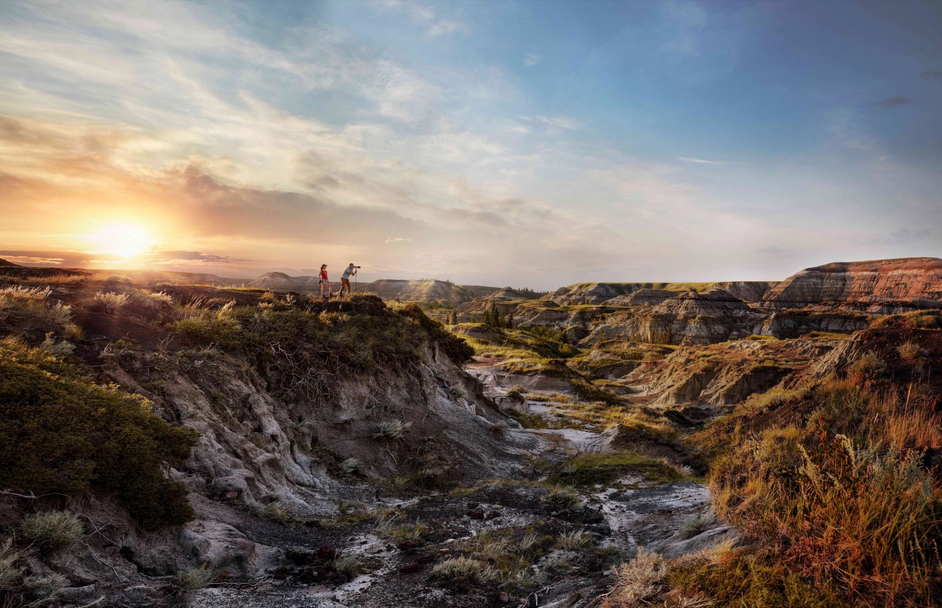 Couple taking photos as the sun goes down at Horseshoe Canyon.