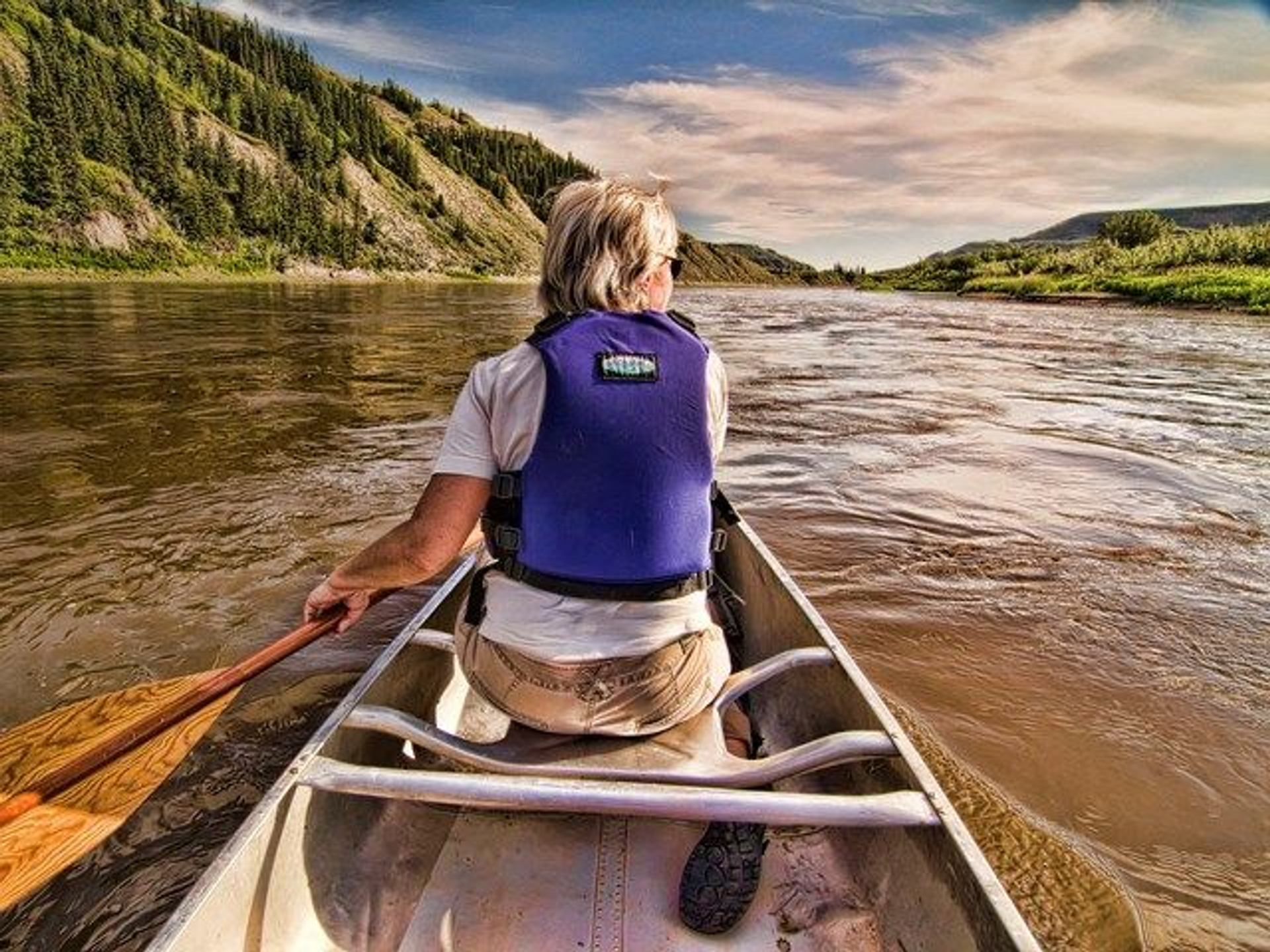 A man canoeing down the river.