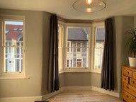 Inside view of a living room, showing their sash windows