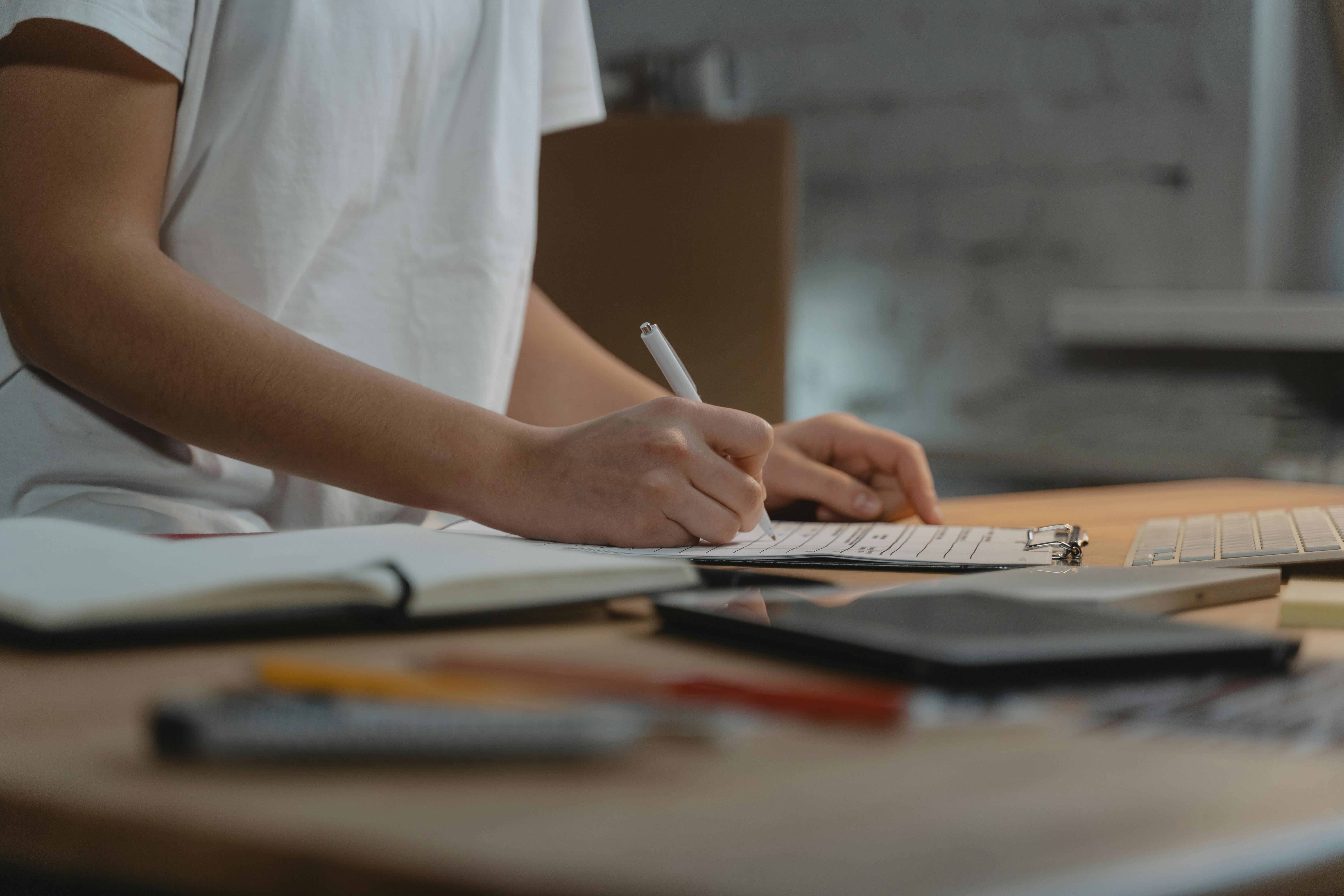 Hyper-realistic documentary photography, a clipboard with audit checklist papers and a red pen resting on a stainless steel workbench in a factory, blurred machinery and workers in the background, natural side lighting from a factory window creating depth, cool industrial blue-grey tones with red pen as focal accent, cinematic depth of field, no text, no brand logo