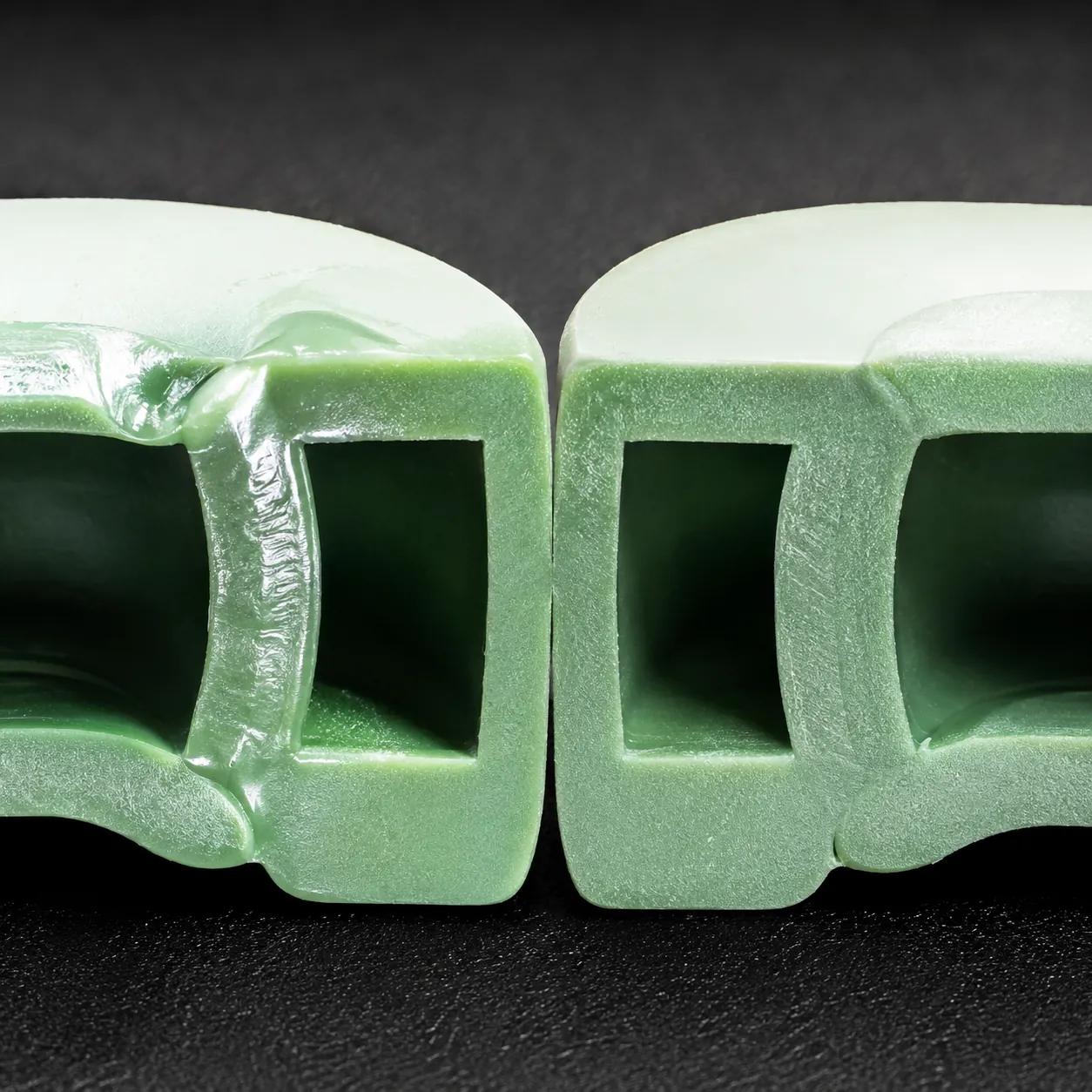 Hyper-realistic product photography, a cross-section of a PPR fusion joint showing a cold weld defect with glossy surface, next to a correctly fused matte joint, macro lens shot with harsh studio lighting to highlight texture difference, no text, no brand logo