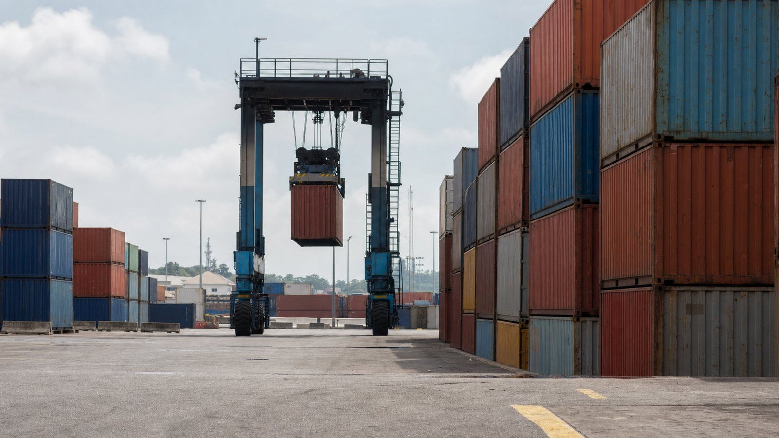 Stacked shipping containers in a West African terminal yard, where a consignment without a Certificate of Conformity accrues storage while a destination inspection is arranged