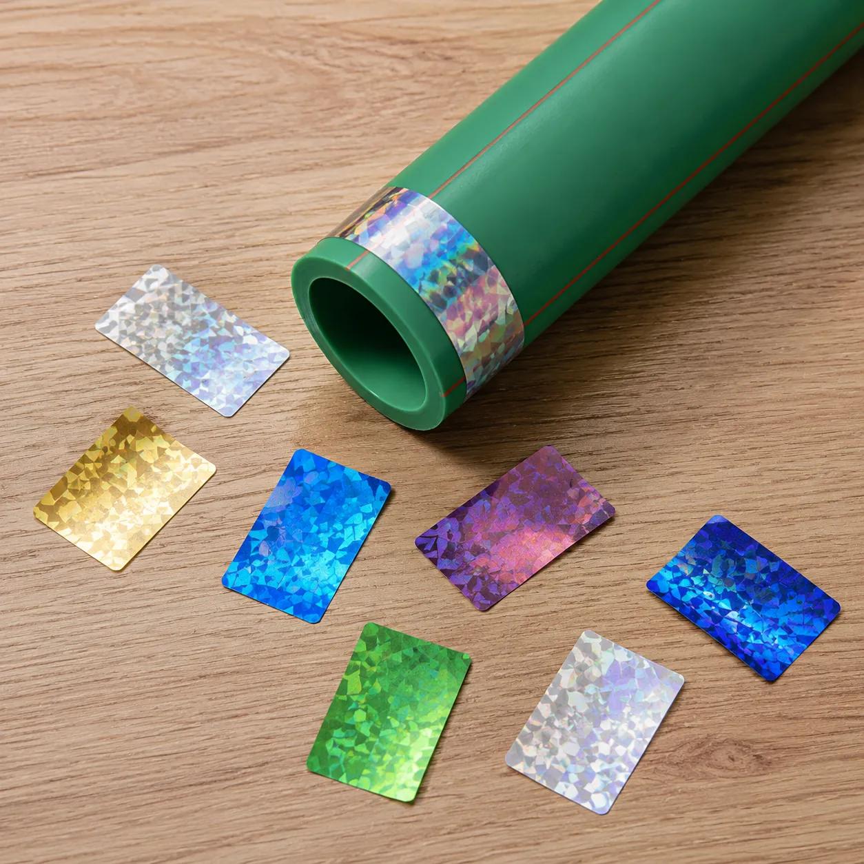 Hyper-realistic product photography, top-down view of a wooden desk with a PPR pipe and multiple holographic security stickers in different colors, soft shadow, studio lighting, no text, no brand logo
