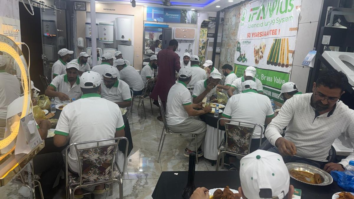 Plumbers in IFANPlus uniforms fill the dealer showroom for dinner