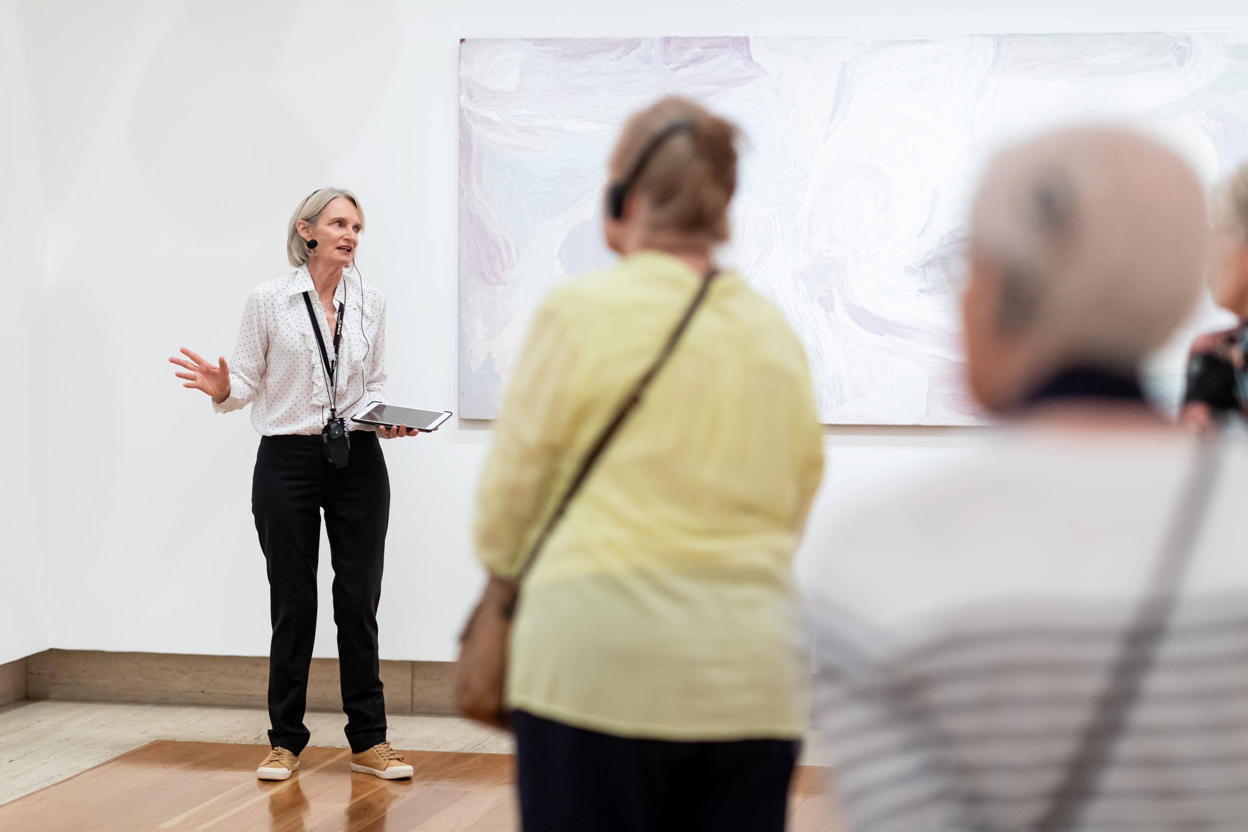 Visitors using assistive listening technology on a guided tour at QAG | Photograph: C Callistemon