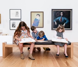 Visitors drawing in the Queensland Art Gallery featuring (left to right) portraits by William Yang, Australia b.1943; Ernestine Hill 1970 by Sam Fullbrook, Australia 1922‑2004 and The Cypriot 1940 by William Dobell, Australia 1899-1970 / © The artists or their representatives / Photograph: J Ruckli © QAGOMA