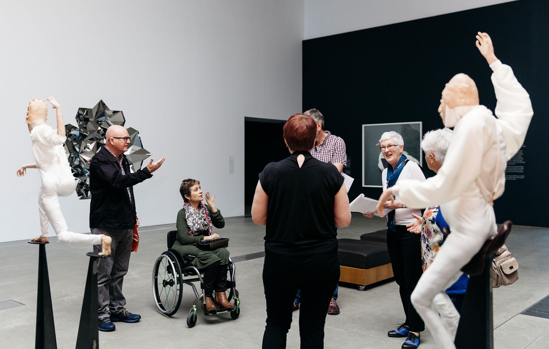 An Auslan interpreter accompanies the volunteer guide on tours for Deaf visitors