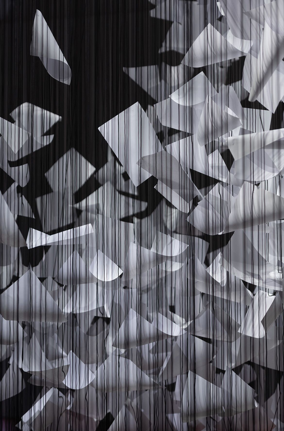 Chiharu Shiota, Japan/Germany b.1972 / Installation view of A question of perspective 2022 in ‘The Soul Trembles’, Gallery of Modern Art, Brisbane / Polypropylene ropes, 80mg paper, found furniture, cable ties, staples / 500 x 810 x 1215cm / Commissioned 2022 with funds from Tim Fairfax AC through the Queensland Art Gallery | Gallery of Modern Art Foundation / Collection: Queensland Art Gallery | Gallery of Modern Art / © Chiharu Shiota / Photograph: M Campbell © QAGOMA