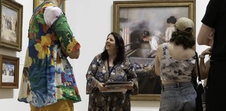 A Volunteer Guide leads visitors on a tour at the Queensland Art Gallery. / Photograph: C Baxter / © QAGOMA