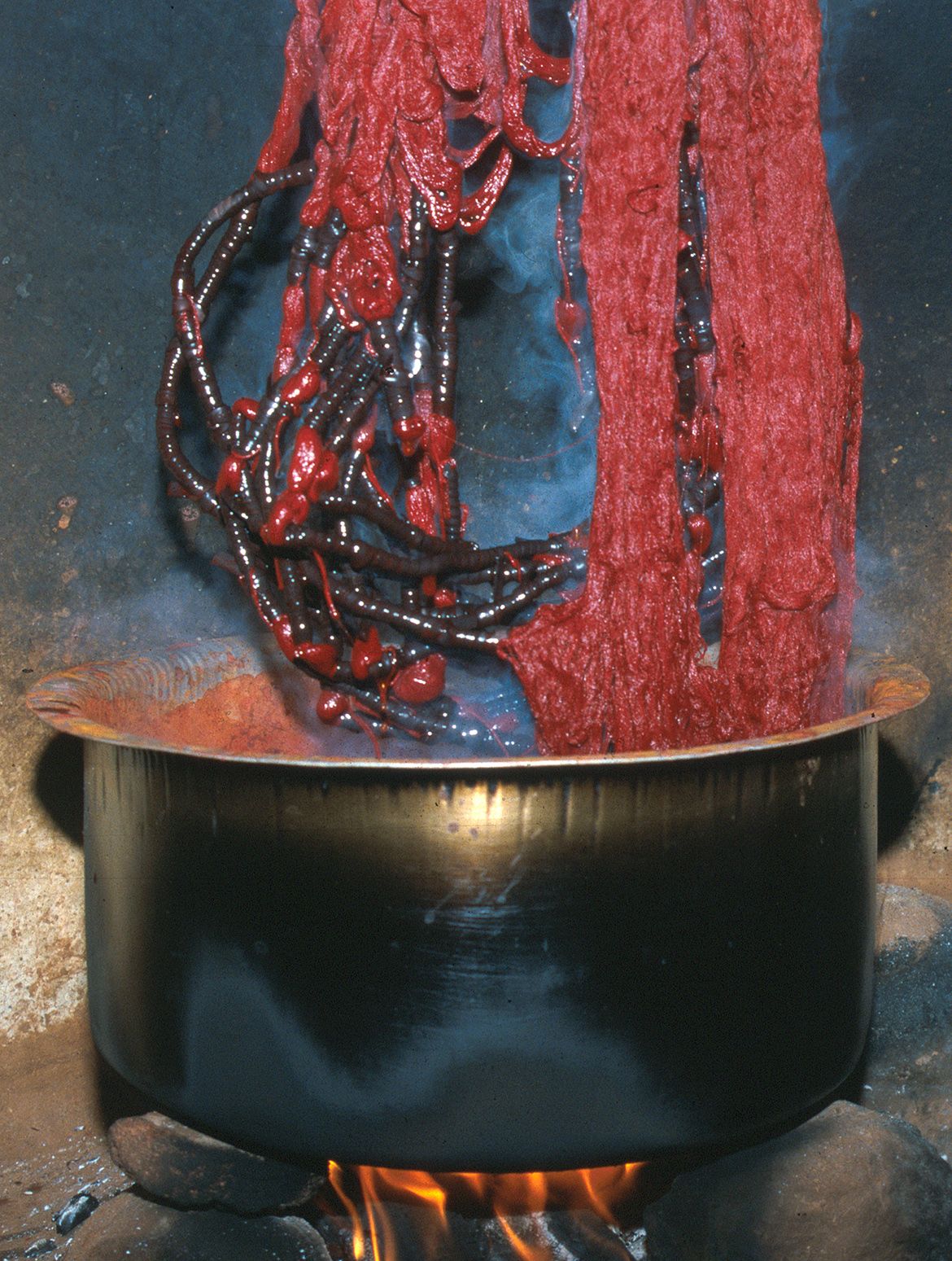 Yarn is removed from a red dye pot — always the first colour to be applied, Puttapaka, 1999 / Photograph: Dana McCown