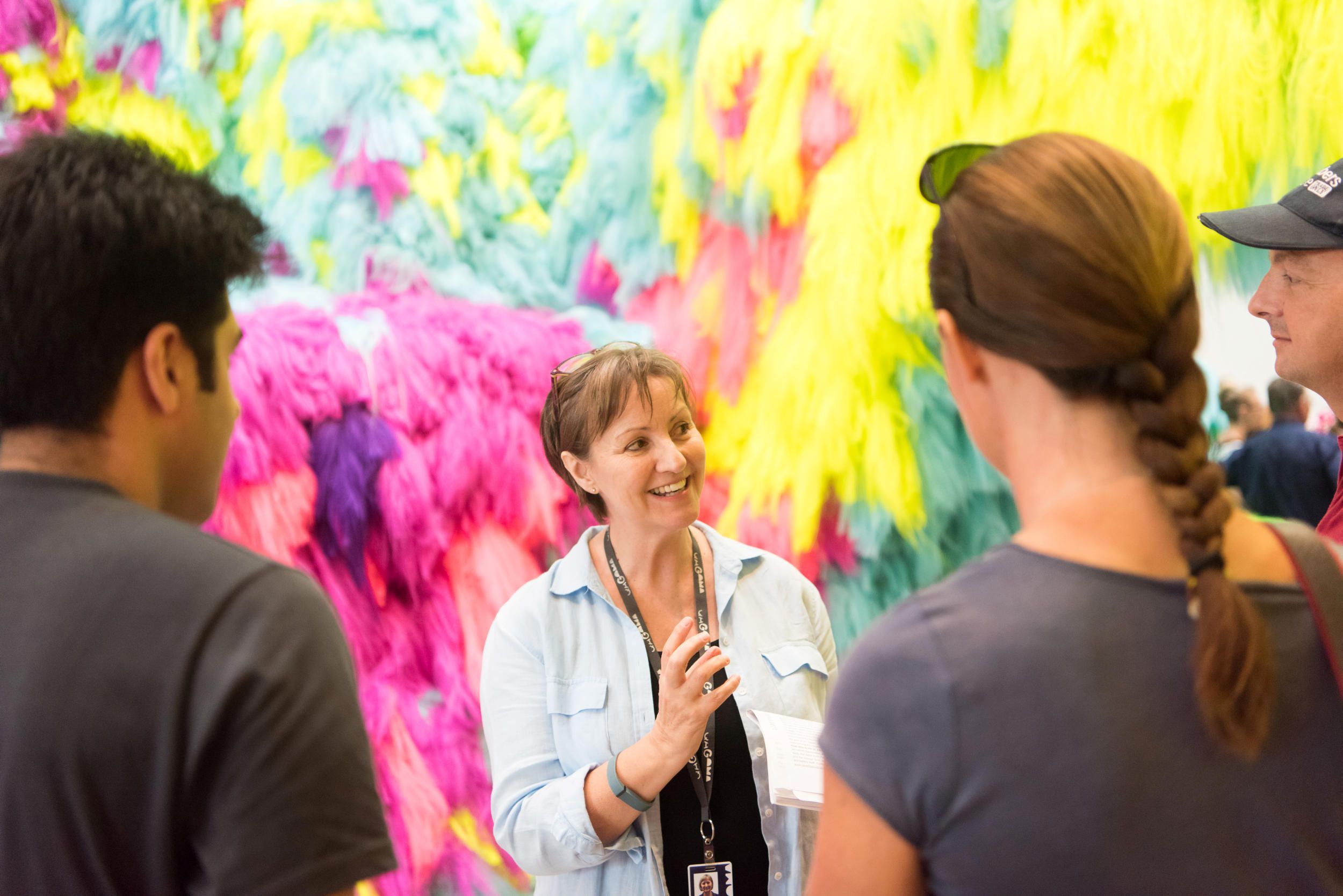 A Volunteer Guide engages visitors on a tour at the Gallery Of Modern Art. Photography by M. Sherwood | QAGOMA
