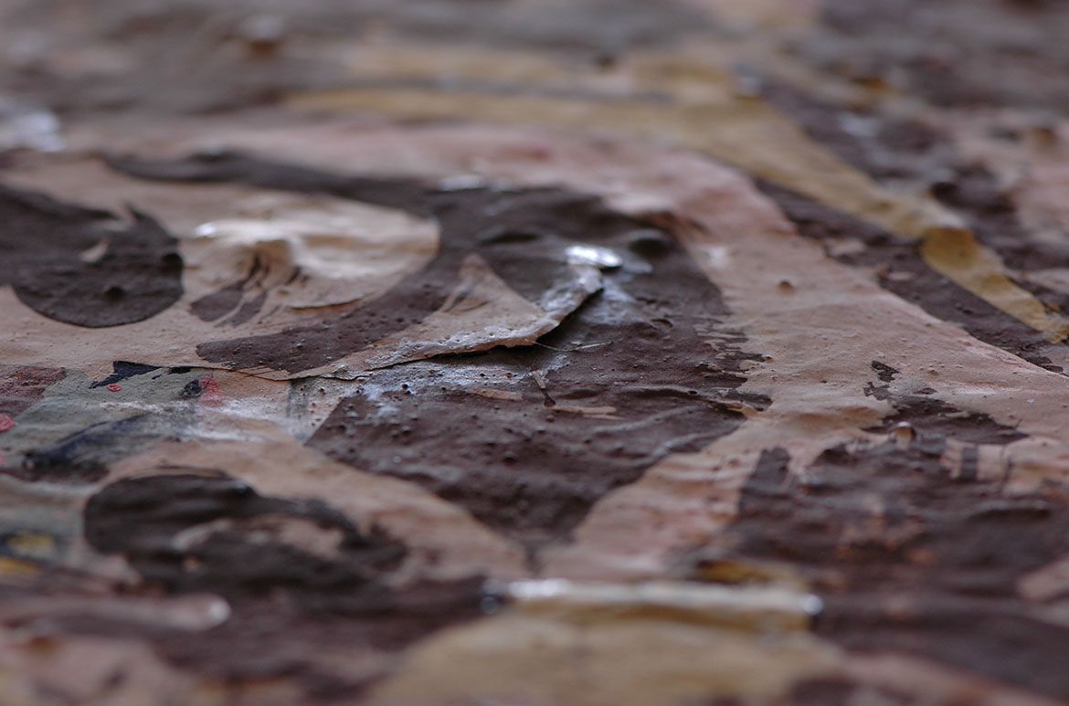 View of an area of lifting paint on Punch and Judy 1964. Previous application of glue in an unsuccessful repair is visible as shiny excess around the paint crack