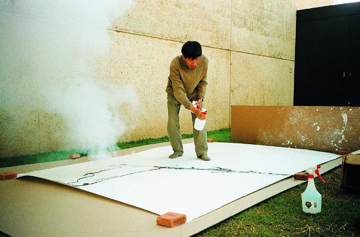Cai Guo-Qiang carrying out a number of gunpowder trials and tests