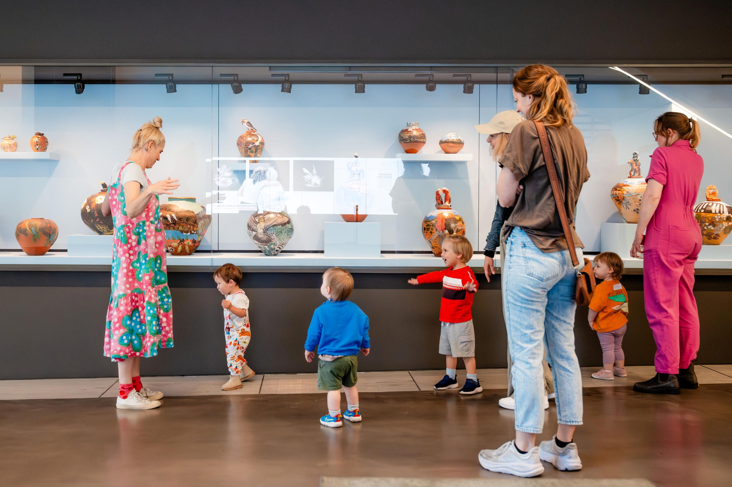 Art Play Date attendees looking at artworks in the Gallery, 2025 / Photo by J Ruckli / ©QAGOMA