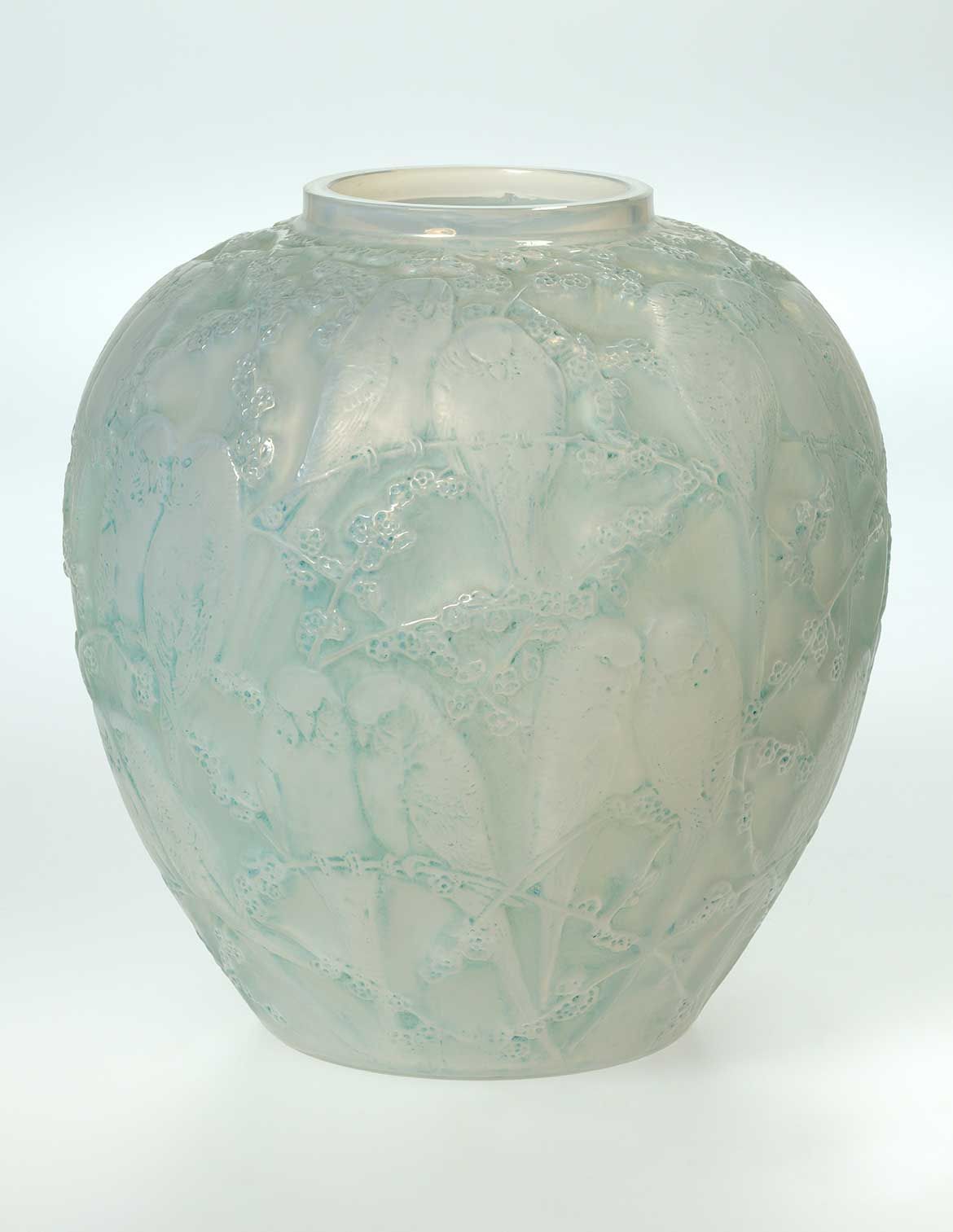 René Lalique, France 1860-1945 / Perruches (Parakeet) vase designed 1919 / Mould blown blue opalescent and frosted glass with grey patina / 25 x 24 x 24cm / Purchased 2018. QAGOMA Foundation / Collection: Queensland Art Gallery | Gallery of Modern Art