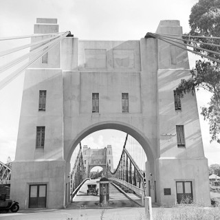 Arthur McLeod / Indooroopilly Toll Bridge c.1940 / 32086-0004-0017 / Image courtesy: John Oxley Library, State Library of Queensland, Brisbane / Construction work began on the Indooroopilly Toll Bridge (now known as the Walter Taylor Bridge) in 1930, opening to traffic 14 February 1936. Designed and built by Walter Taylor for the Indooroopilly Toll bridge Ltd. under the Queensland Government Franchise.