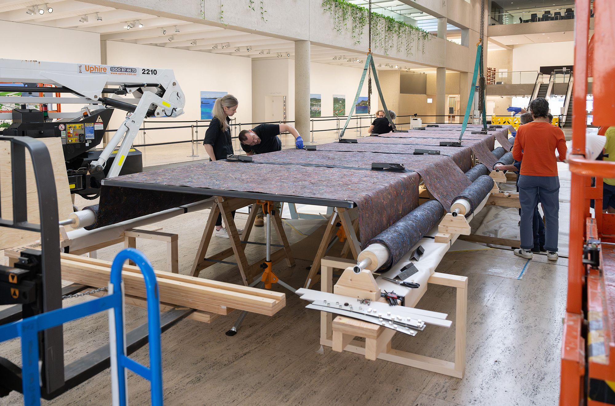 Mit Jai Inn, Thailand b.1960 / Installation of Untitled (Tunnel #APT) 2024 / Oil on canvas / Eight parts: 150 × 1200cm (each, approx.) / Site specific work commissioned for ‘The 11th Asia Pacific Triennial of Contemporary Art’, Queensland Art Gallery Watermall, 2024 / © Mit Jai Inn / Courtesy: The artist and Silverlens, Manila and New York / Photograph: N Umek © QAGOMA