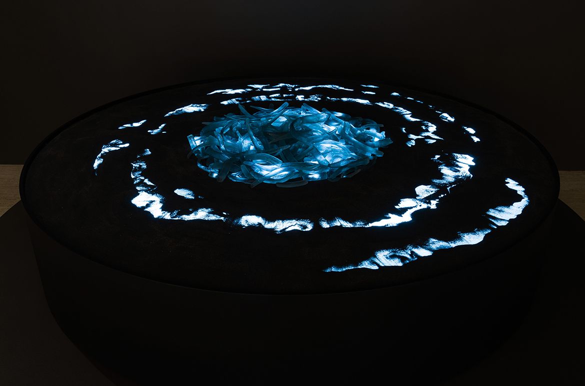 Megan Cope, Quandamooka people, Australia b.1982 / The tide waits for no one 2020–21 / Kiln cast glass, mineral sand, lightbox / 250 pieces: 40 x 200(cir.) cm (installed) / Courtesy: Megan Cope and Milani Gallery, Brisbane