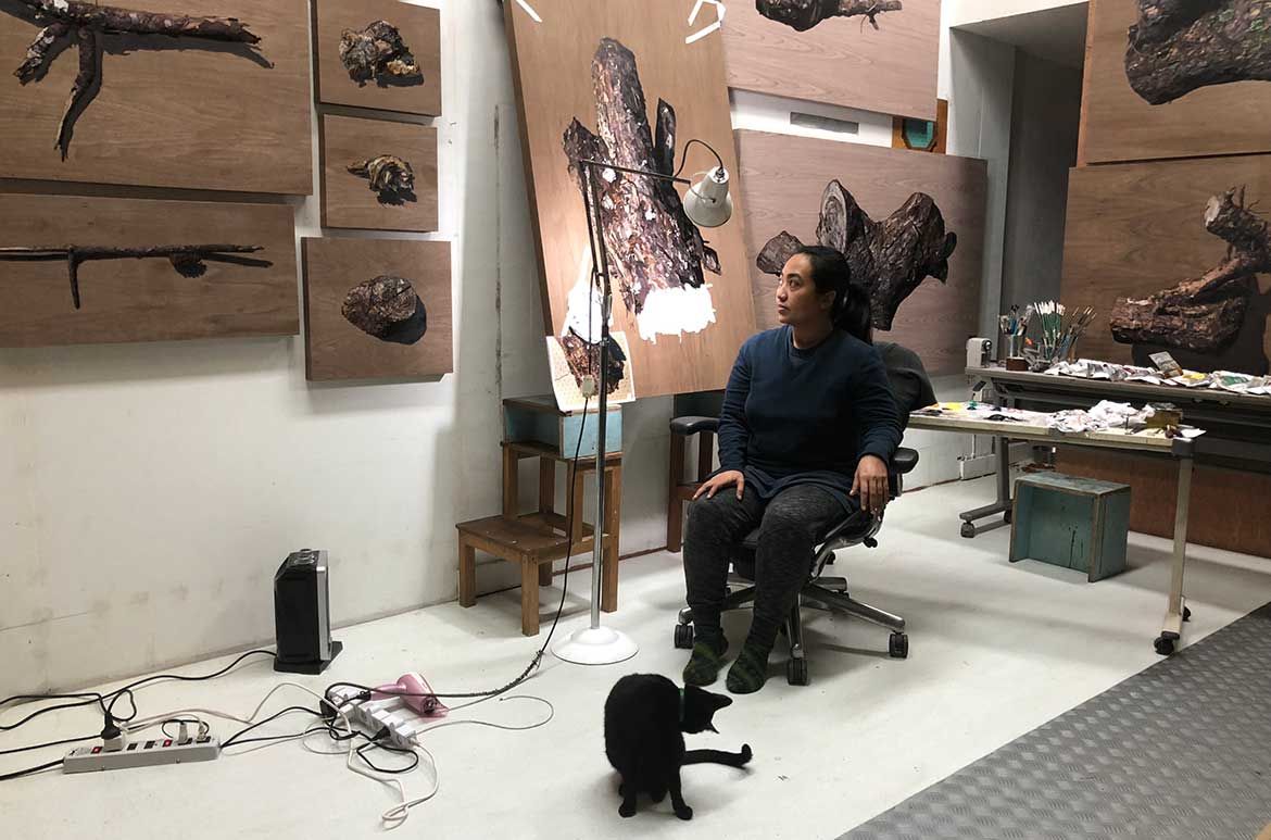 Nona Garcia in her studio with her suite of paintings, Untitled pine
tree 2018 / Photograph: Kawayan de Guia / Image courtesy: The artist