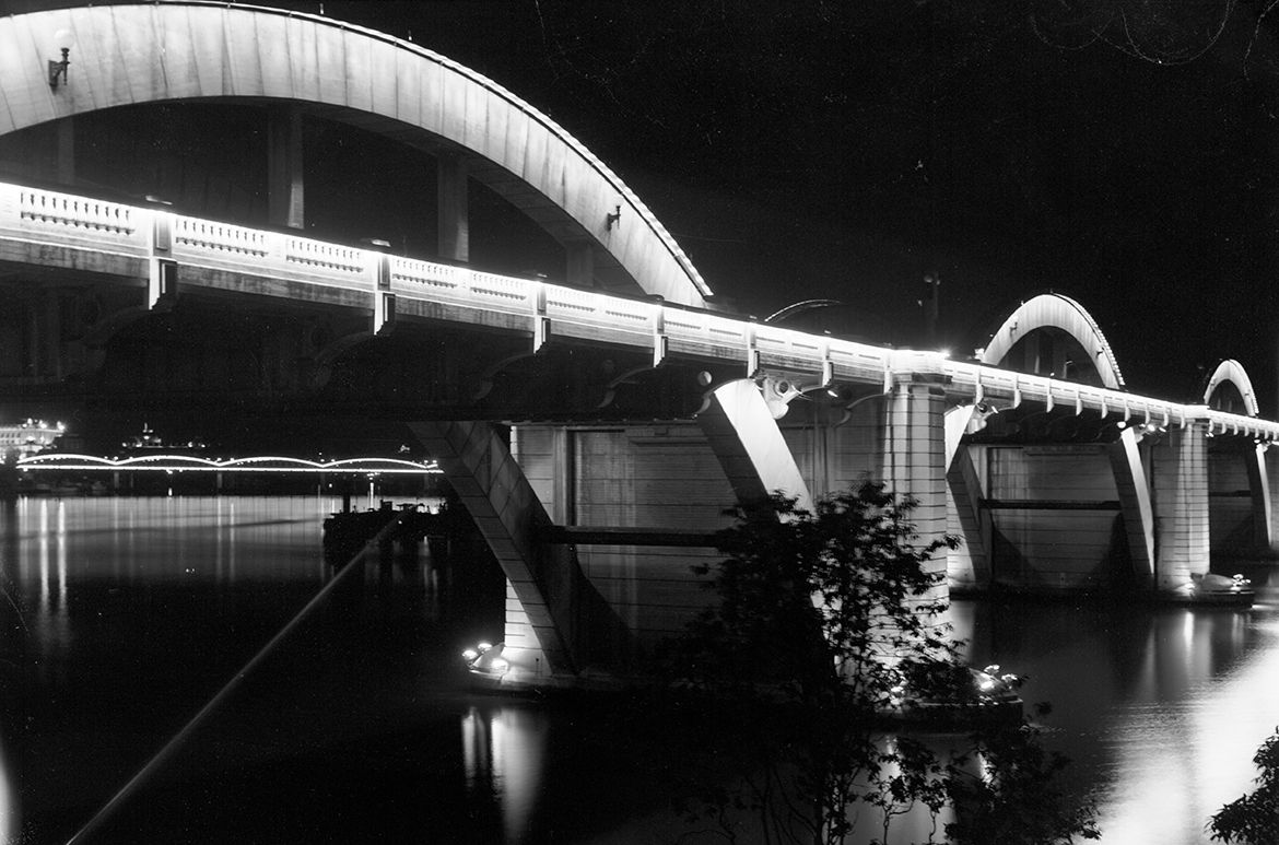 Grey Street Bridge lit at night pre 1967, showing the second Victoria Bridge in the distance / PR 3317485 Neg No.C2-1055 / Image courtesy: Queensland State Archives