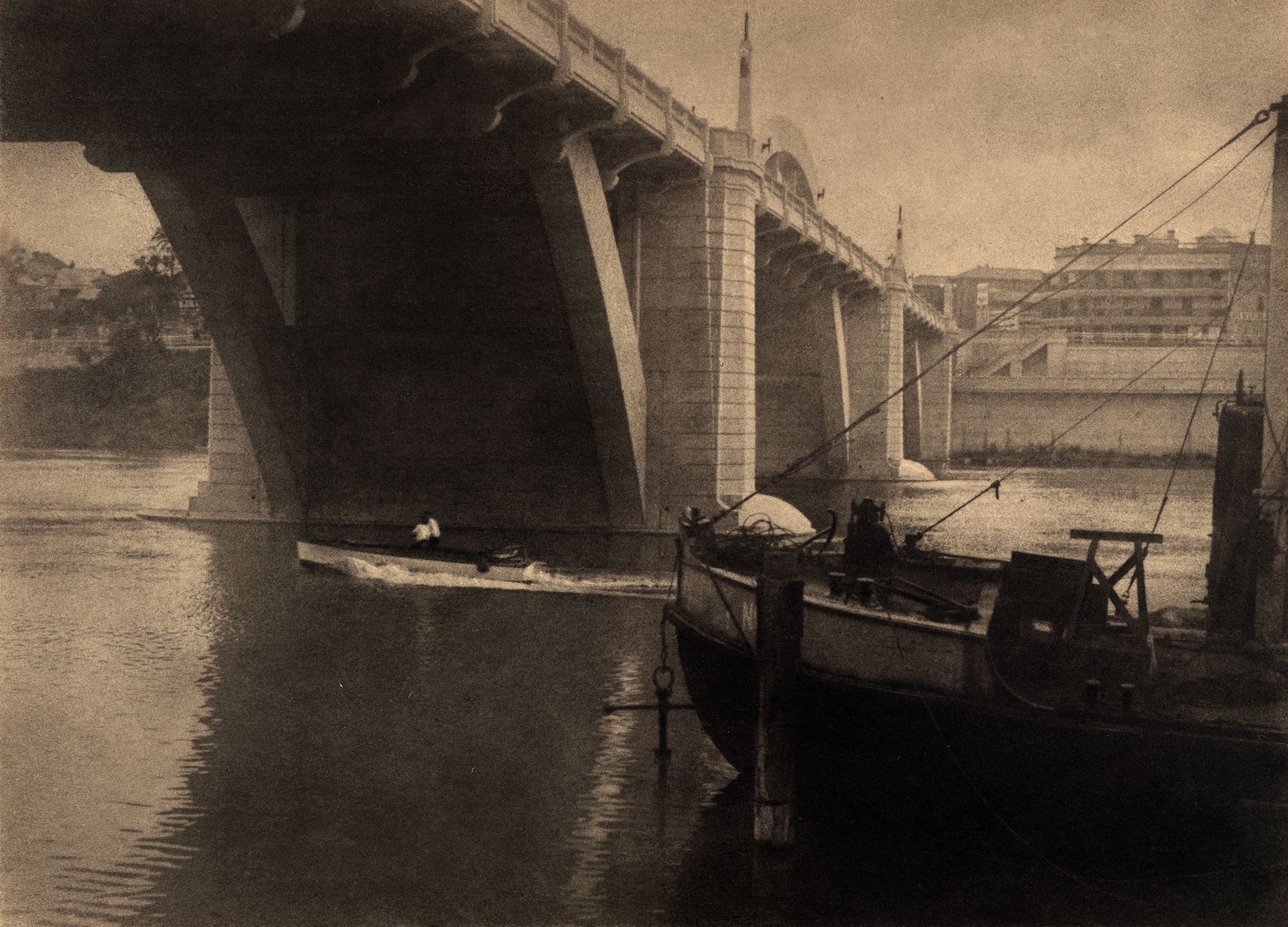 Stanley W Eutrope, Australia 1891–1983 / Under the bridge (Grey Street Bridge, Brisbane) c.1933 / Bromoil photograph on paper / 21.5 x 29.7cm (comp) / Gift of Mrs J. Searston in memory of her mother, Mrs Florence Radford, through Miss Shirley Eutrope 1984 / Collection: Queensland Art Gallery | Gallery of Modern Art / © Stanley Eutrope Estate