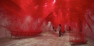 Chiharu Shiota, b.1972, Kishiwada, Osaka Prefecture, Japan. Uncertain Journey 2016/2019. Metal frame, red wool / Dimensions variable. Courtesy: Blain | Southern, London/Berlin/New York. Installation view: Shiota Chiharu: The Soul Trembles, Mori Art Museum, Tokyo, 2019. Image courtesy: Mori Art Museum, Tokyo. Photograph: Sunhi Mang