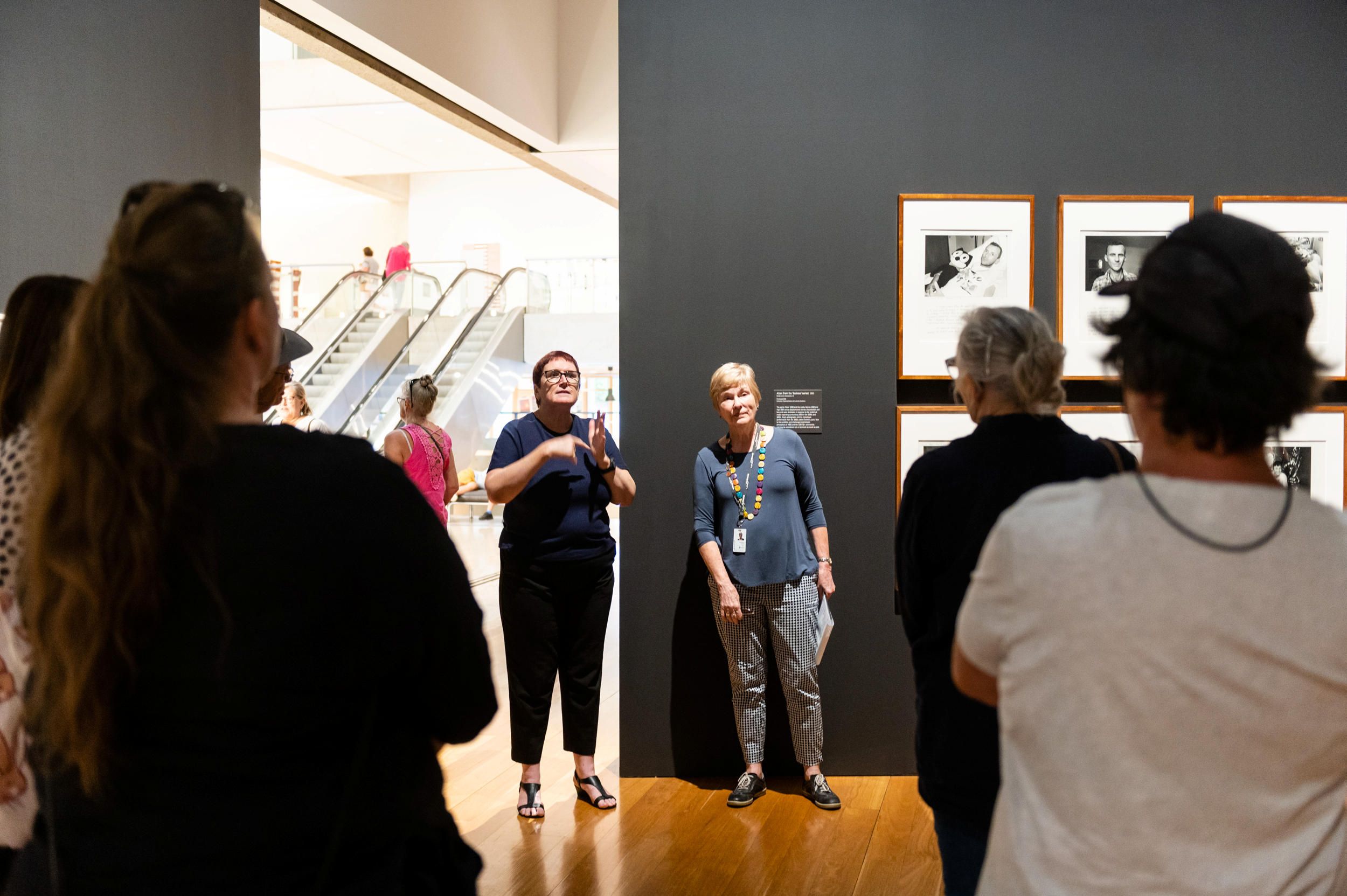An Auslan interpreter accompanies a volunteer guide on a tour for d/Deaf visitors in QAG. Photograph by M. Pricop | QAGOMA