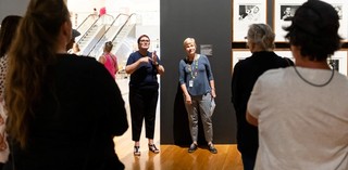 An Auslan interpreter accompanies a volunteer guide on a tour for d/Deaf visitors in QAG. Photograph by M. Pricop | QAGOMA