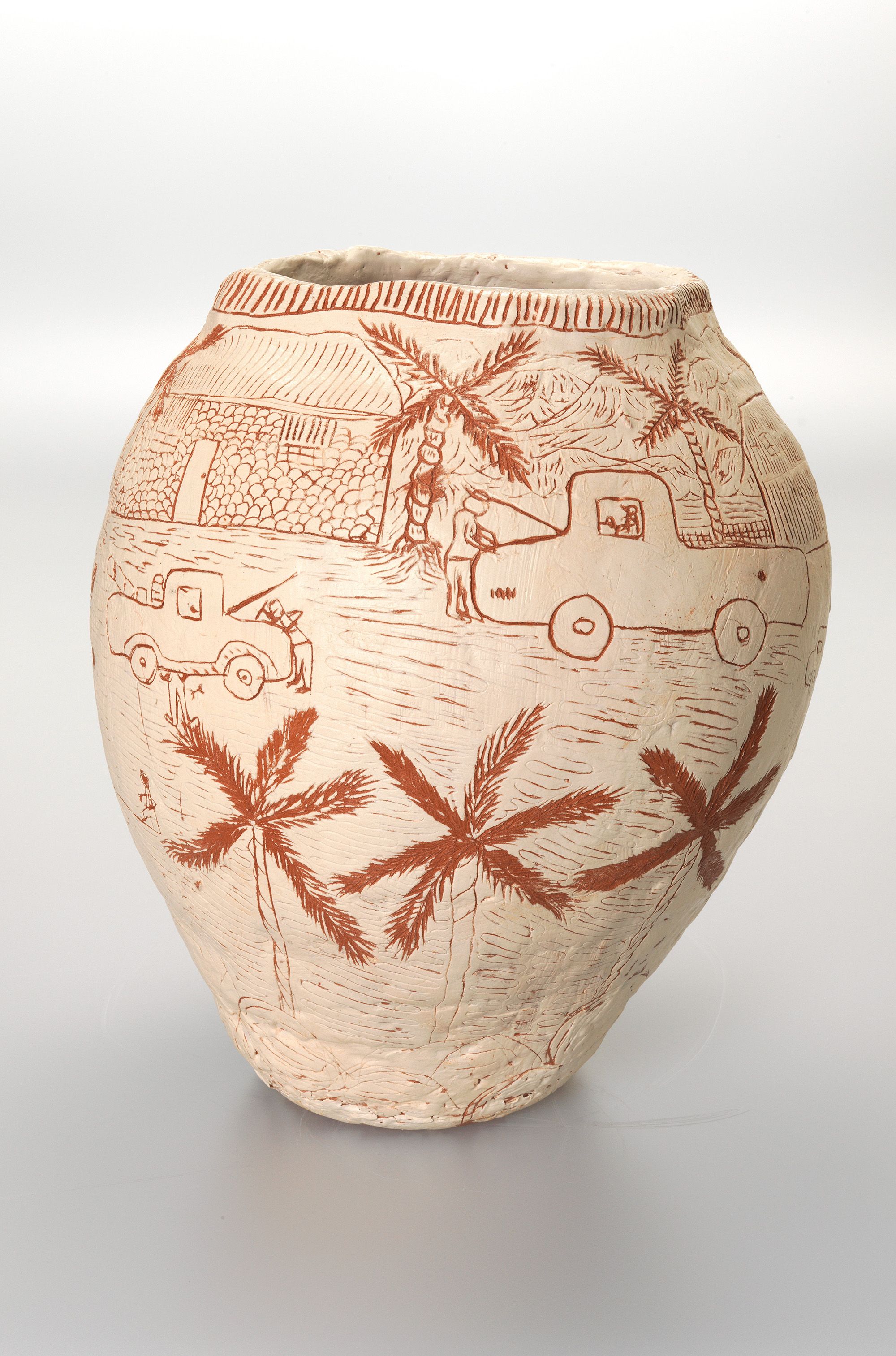 Hermannsburg Potters, Northern Territory, Australia est. 1990 / Clara Inkamala, Arrernte people, Australia b.1954 / Ntaria Garage 2007 / Hand-built terracotta clay with incised white slip beneath clear glaze / 34 x 25cm (diam.) / Purchased 2007. QAG Foundation Grant / Collection: Queensland Art Gallery | Gallery of Modern Art / © Clara Inkamala/Copyright Agency / Sgraffito is a recent addition to the repertoire of the Hermannsburg Potters and has been adapted to much success. Incisions into the white slip contrast against the terracotta base to create a strong visual effect through which the artists convey their story. Inkamala shows the old Ntaria (Hermannsburg) garage, where her uncle worked, the scene is completed by the white stone-built buildings and date palms which make up the old mission headquarters, now known as the Hermannsburg Historical Precinct.