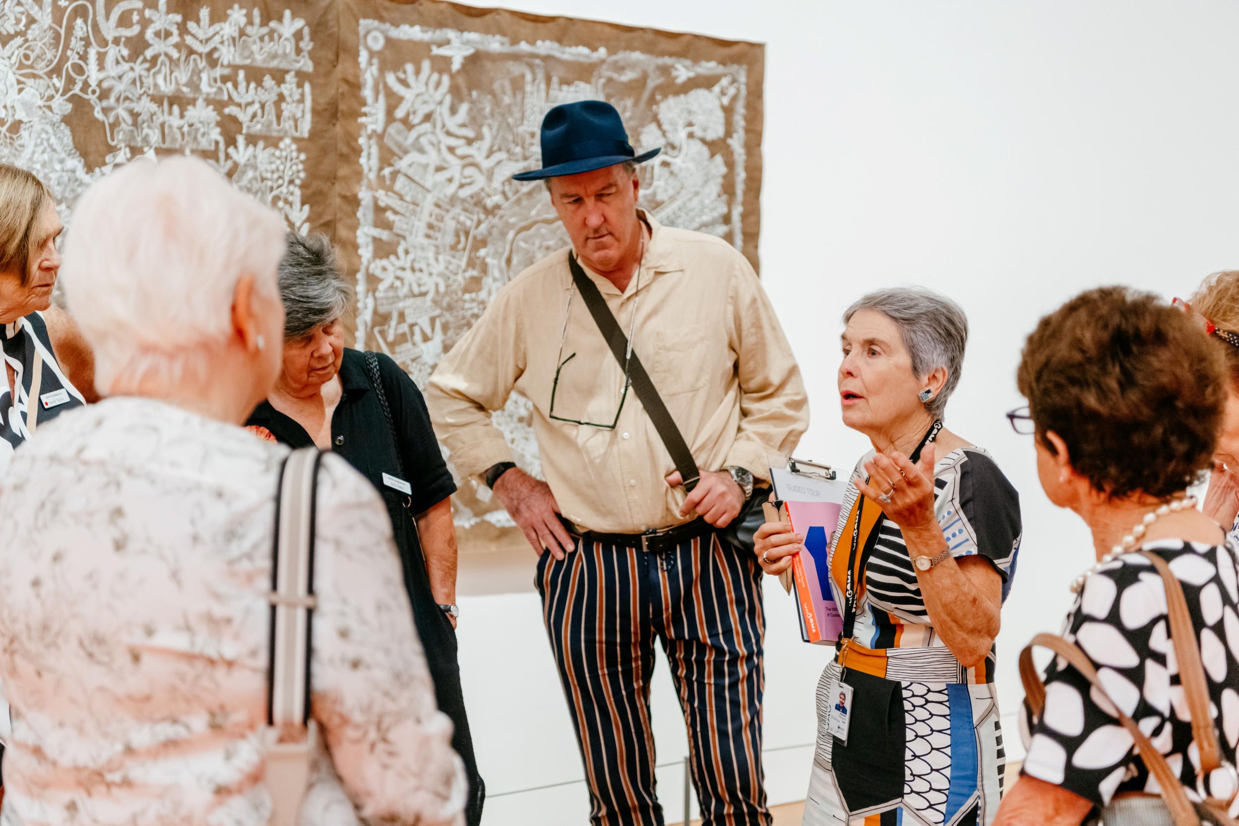 A Volunteer Guide engages visitors on a tour at the QAGOMA.

Photography by Joe Ruckli | QAGOMA